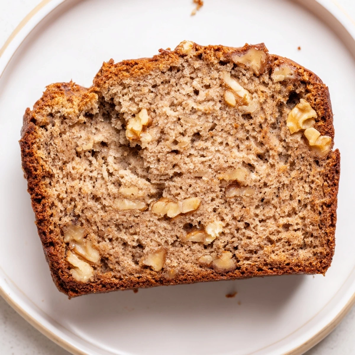 This delicious Simple Banana Bread loaf, perfectly baked with a tender crumb, looks irresistible.