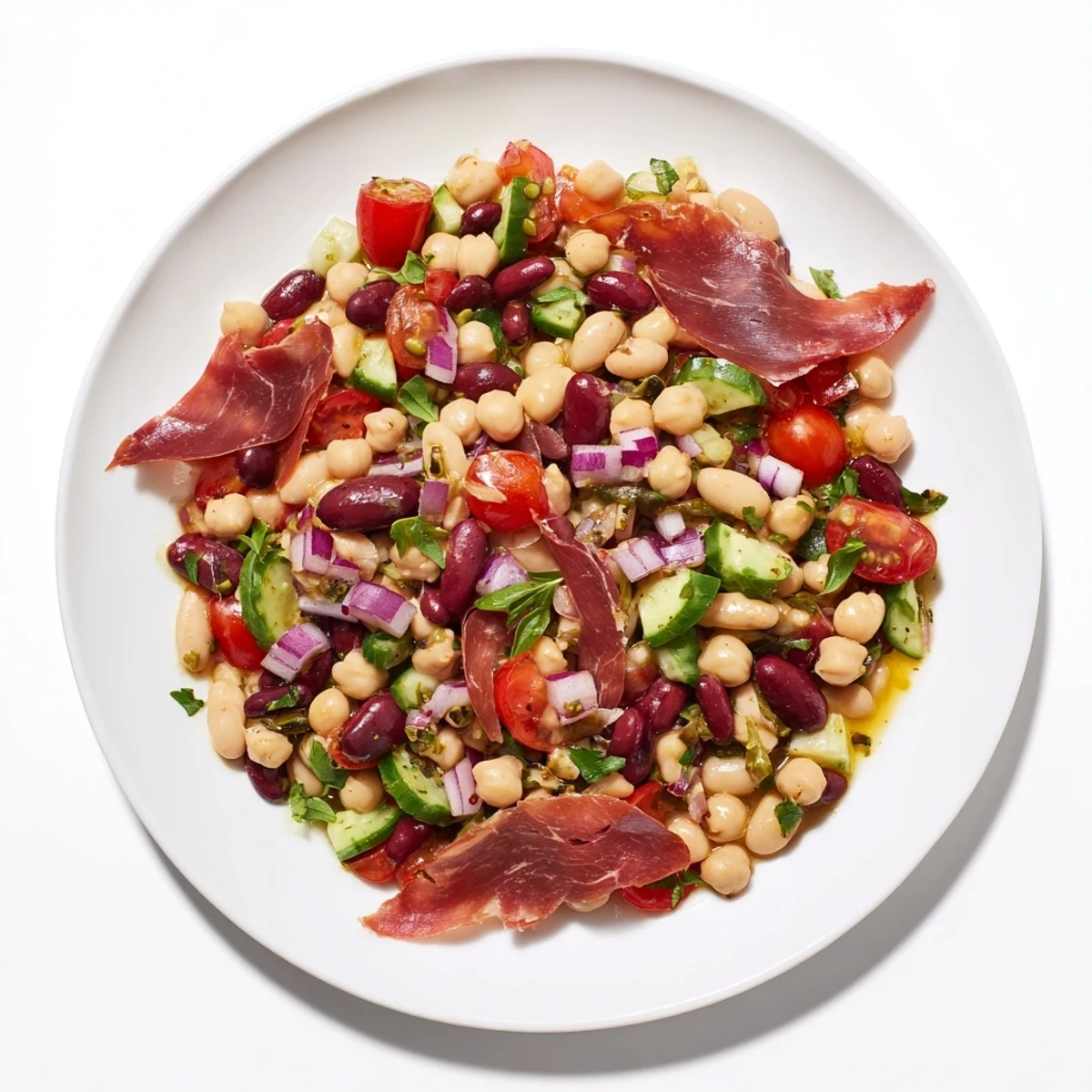 Vibrant Dense Bean Salad with Prosciutto: colorful mix, savory prosciutto, and herby dressing in a bowl.