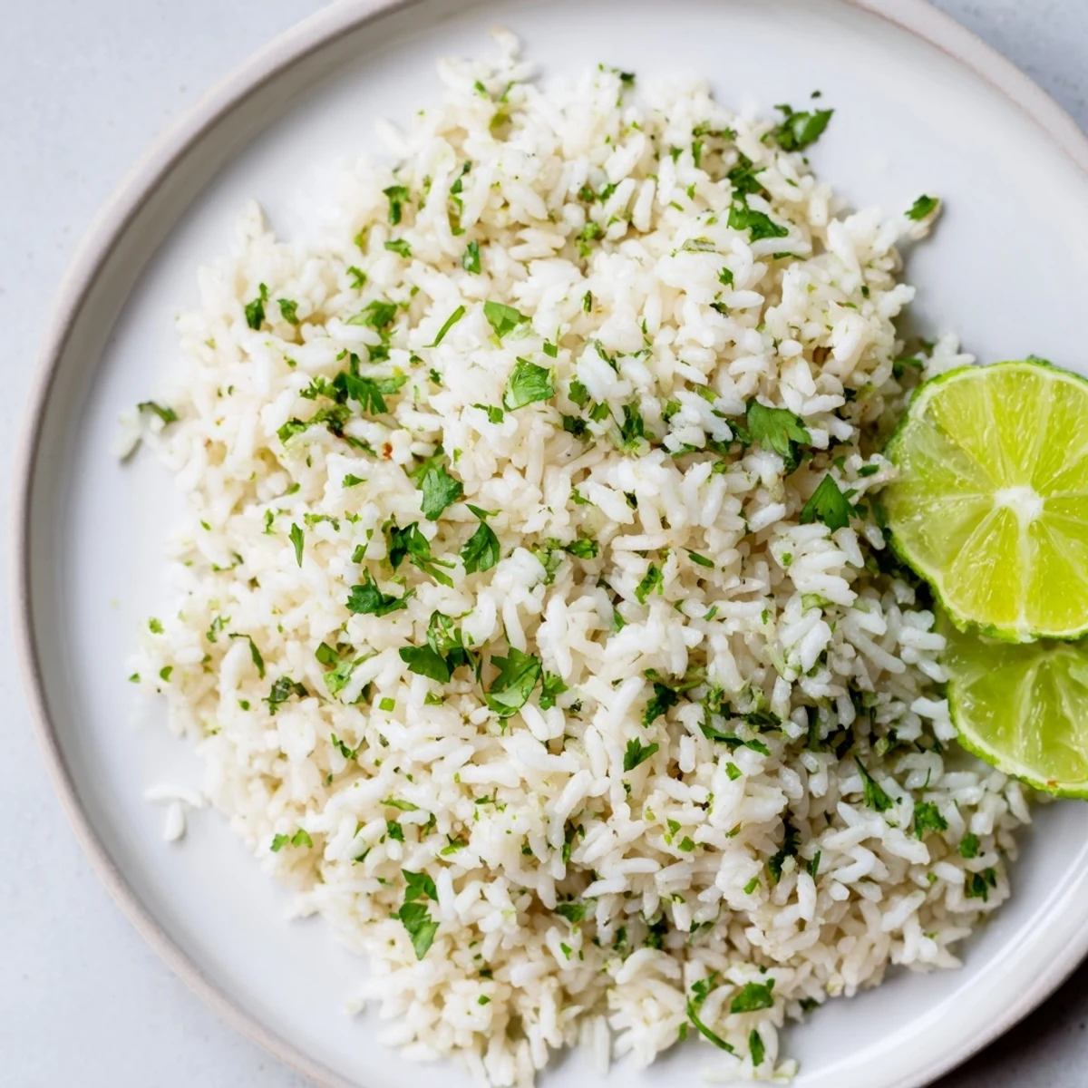 Bright green Cilantro Lime Rice glistens; imagine the fresh taste of lime with every bite.