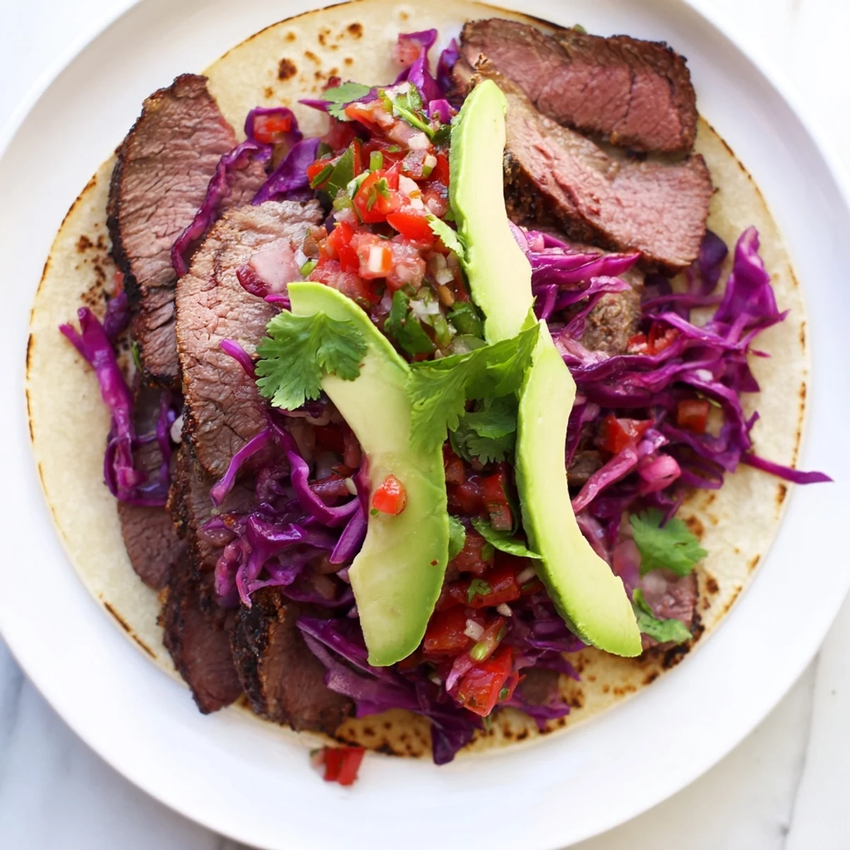 Smoky coffee-rubbed steak tacos, piled high in warm tortillas with colorful toppings, a delicious meal.