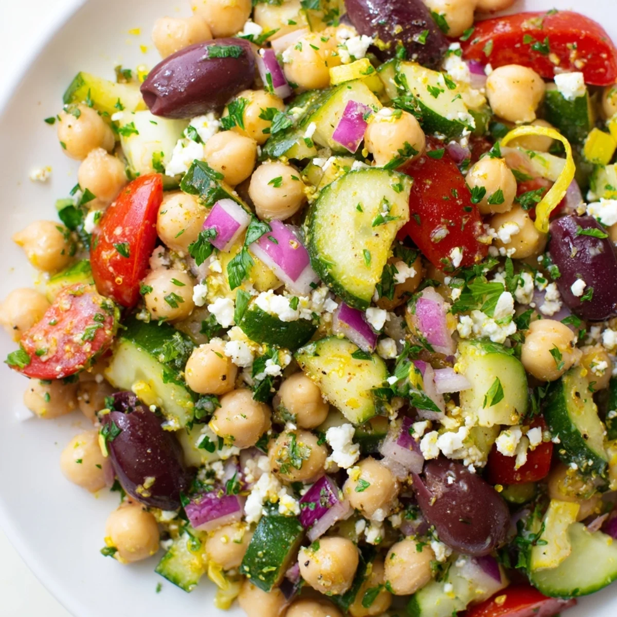 Bright, fresh Mediterranean Chickpea Salad, showcasing juicy tomatoes, olives, and creamy feta, ready to serve.