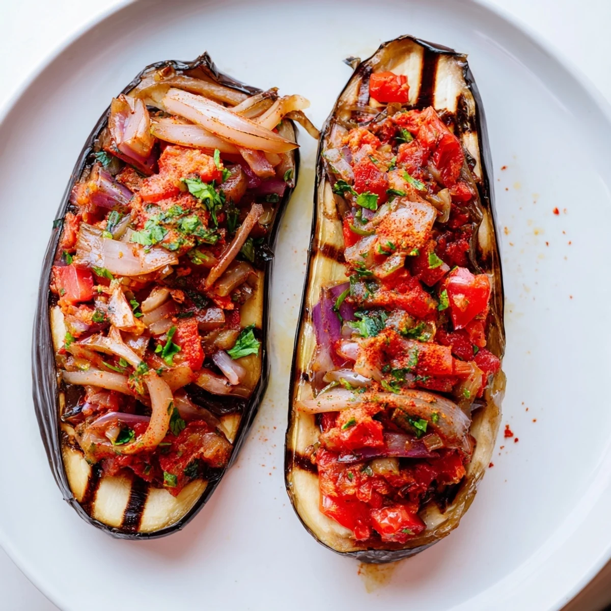 Golden-brown Imam Bayildi, showcasing tender eggplant halves overflowing with savory tomato filling.