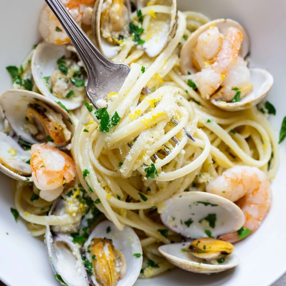 Plated Seafood Linguine served with lemon wedges and parsley, a vibrant Italian-inspired main dish perfect for a coastal dinner.