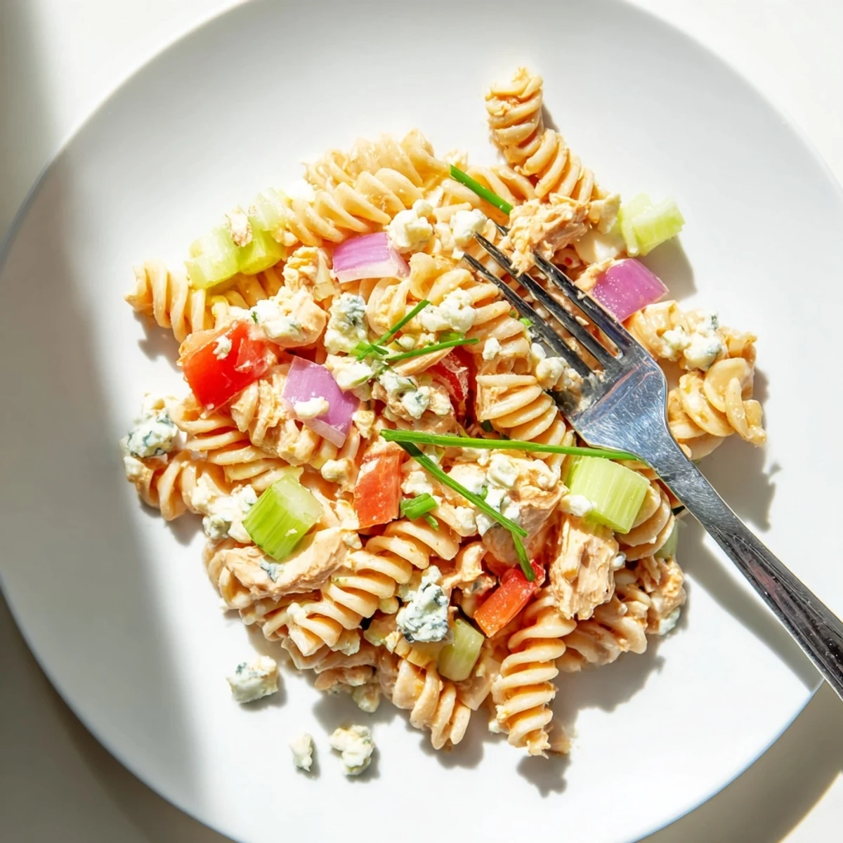 Chilled Buffalo Chicken Pasta Salad with tender shredded chicken, crunchy celery, red pepper, and creamy ranch dressing tossed with rotini pasta.