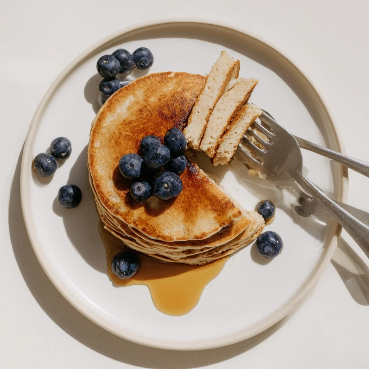 Protein Power Pancakes served warm, topped with fresh blueberries and a dollop of Greek yogurt.