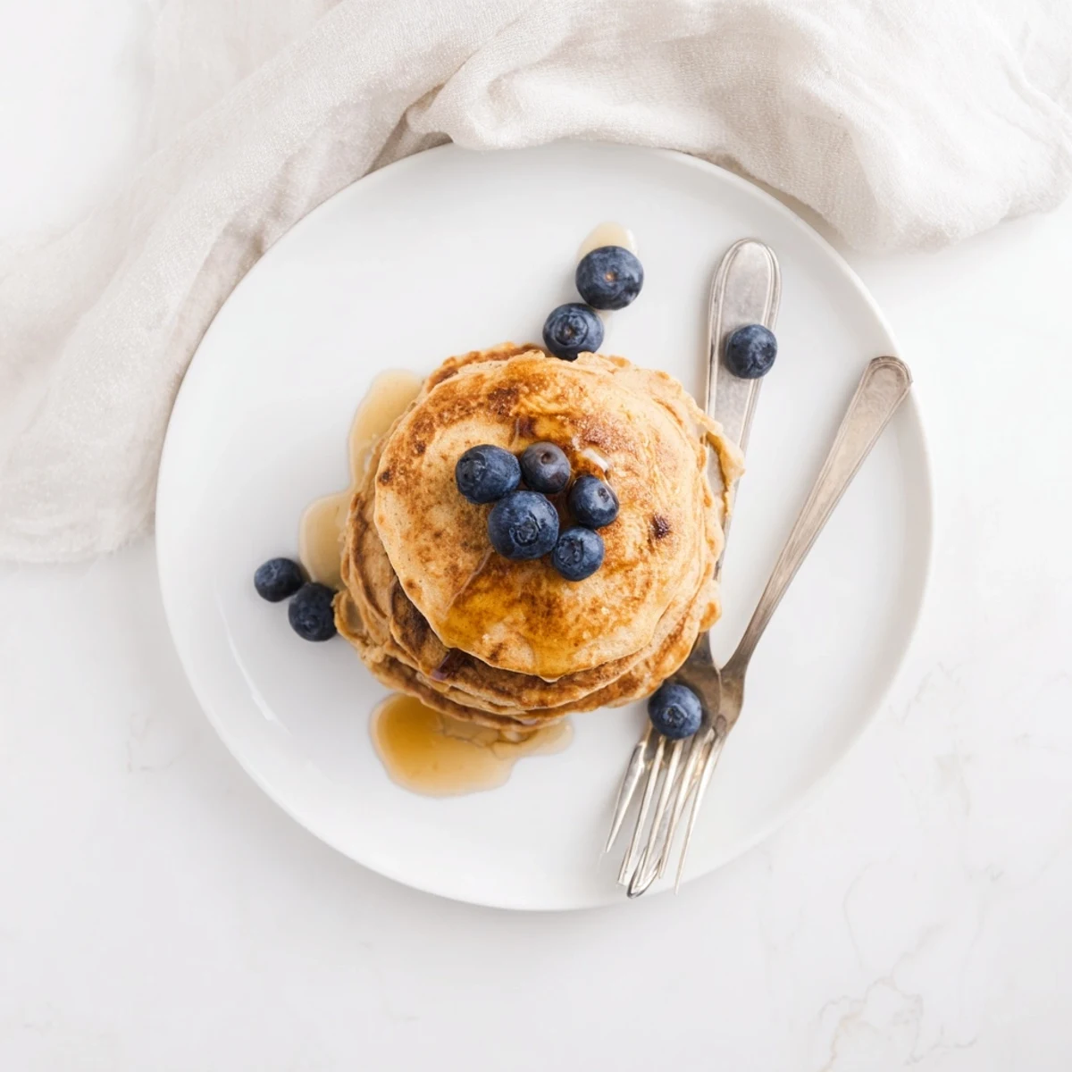 A close-up of Protein Power Pancakes with melted butter, showcasing their fluffy, high-protein texture.