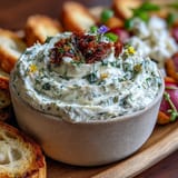 Beautifully arranged spring charcuterie board, featuring goat cheese, prosciutto, and peas.