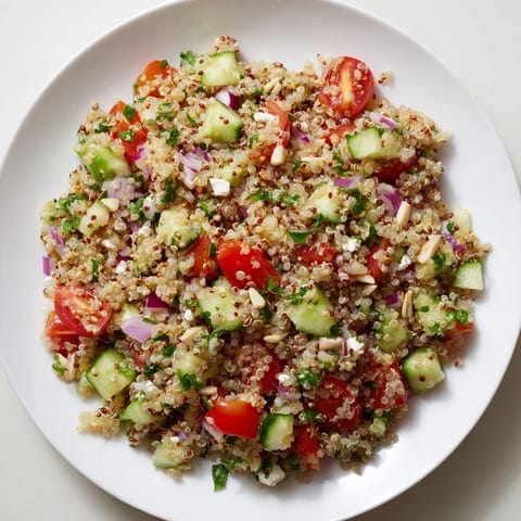Fluffy quinoa salad with lemon vinaigrette, bursting with fresh veggies, ready to enjoy.