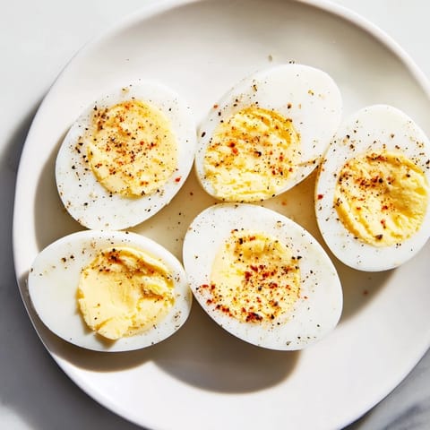 Close-up of perfectly cooked hard-boiled eggs, showing creamy, golden yolks for breakfast.