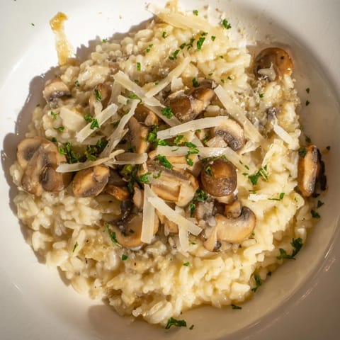 Stove-Top Creamy Risotto: a close-up shows the creamy, Parmesan-laced Italian rice dish, ready to serve.