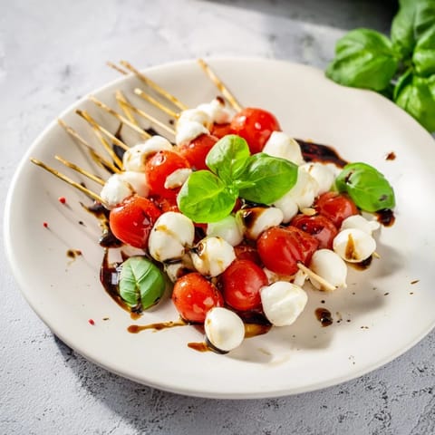 A close-up of Fresh Caprese Salad Skewers, showing the bright red tomatoes and creamy cheese.