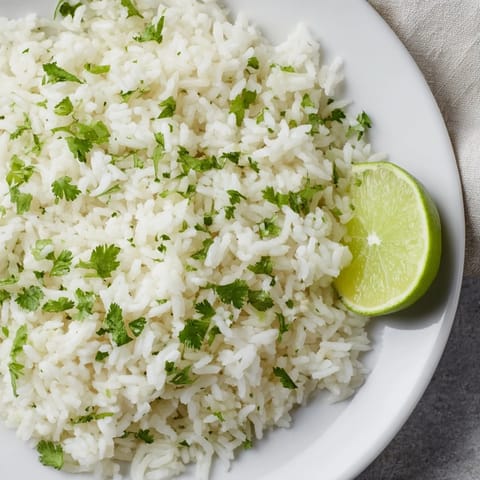 A close-up of fluffy Cilantro Lime Rice, ready to serve alongside your favorite tacos tonight.
