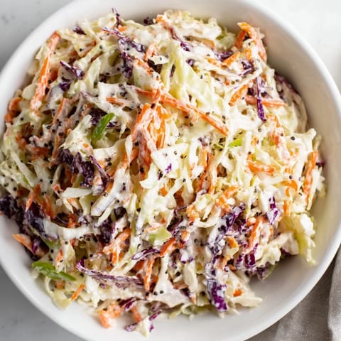 This colorful Quick Coleslaw Salad showcases shredded cabbage and carrots, ready to be tossed with delicious dressing.