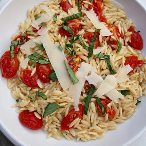 Freshly made orzo tomato Parmesan, tossed with sweet tomatoes and Parmesan cheese, looks so flavorful.