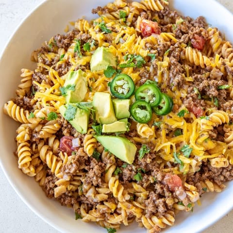 Warm, cheesy Beef Taco Pasta Skillet with cilantro garnish; a comforting Tex-Mex family meal.
