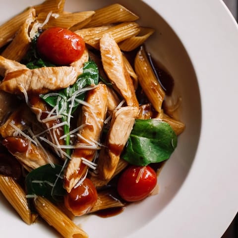 Golden chicken strips glazed in tangy balsamic reduction tossed with al dente penne, sautéed garlic, and fresh baby spinach.