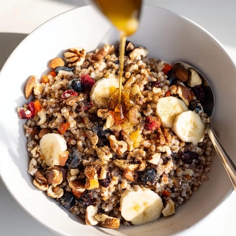 Golden cooked Buckwheat Groats Breakfast in a rustic bowl, drizzled with honey and cinnamon.