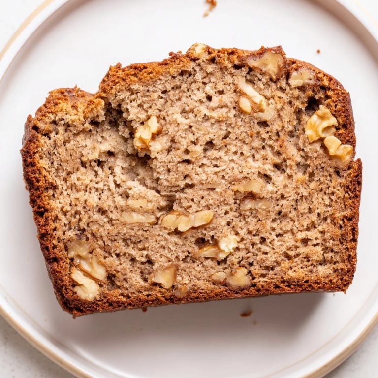 This delicious Simple Banana Bread loaf, perfectly baked with a tender crumb, looks irresistible.