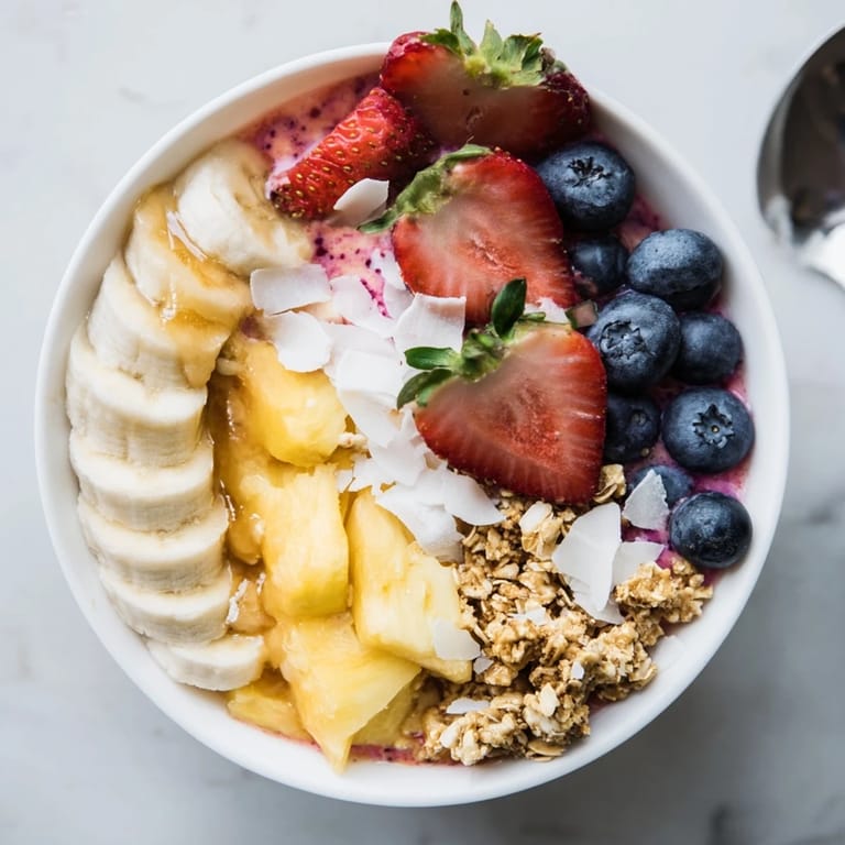 Enjoy a swirl of fruity goodness: these Breakfast Smoothie Packs are topped with granola and coconut shavings, ready to eat.