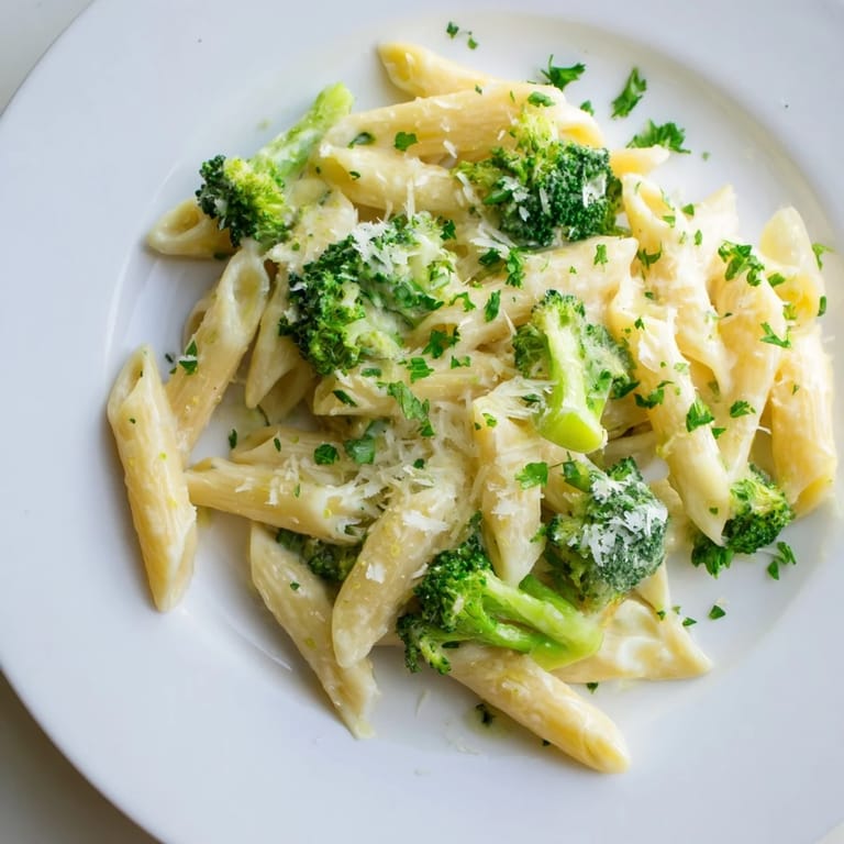 Vibrant image: steaming cream cheese garlic pasta with fresh parsley and grated Parmesan on top.