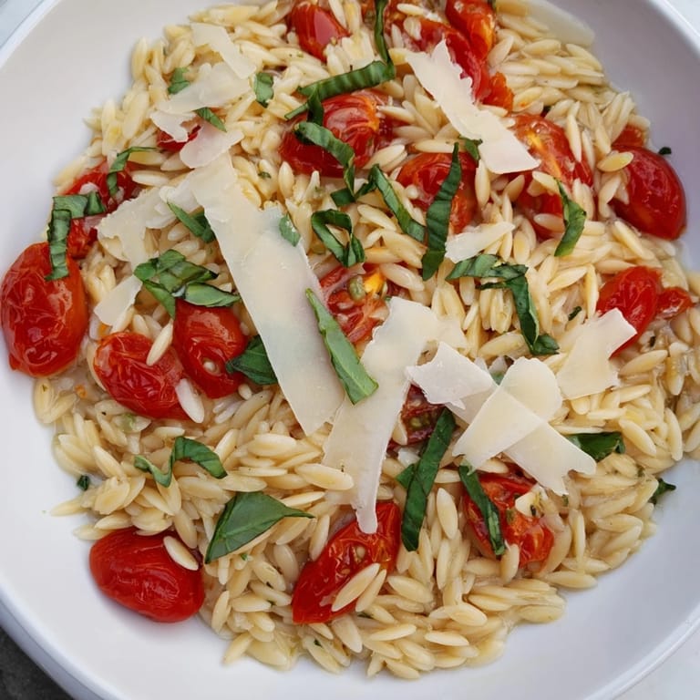 Freshly made orzo tomato Parmesan, tossed with sweet tomatoes and Parmesan cheese, looks so flavorful.