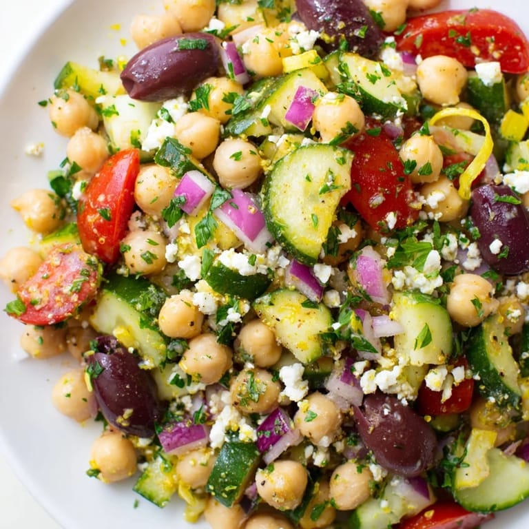 Bright, fresh Mediterranean Chickpea Salad, showcasing juicy tomatoes, olives, and creamy feta, ready to serve.