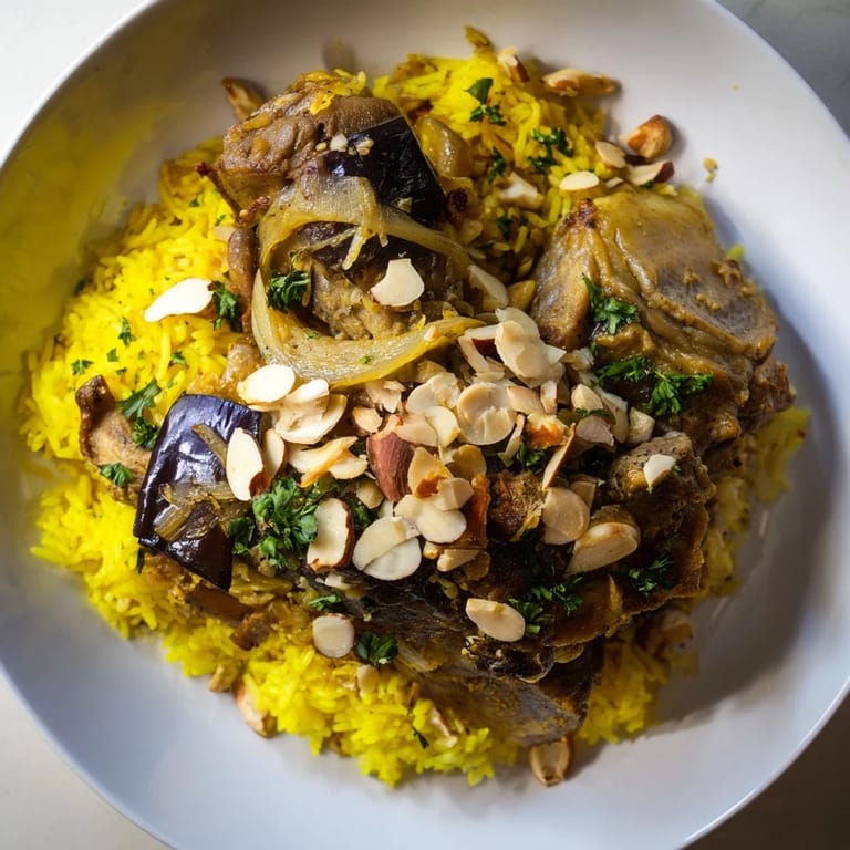 Steaming hot Maqluba, the Palestinian upside-down rice dish, with toasted nuts and fresh herbs.