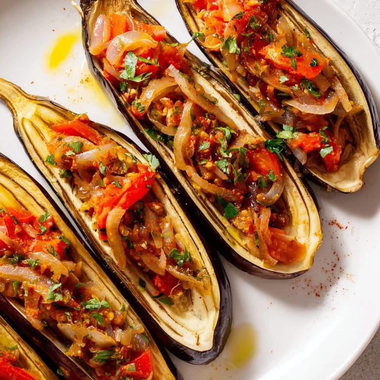 Freshly baked Imam Bayildi, with a glistening, flavorful tomato and herb-filled eggplant, perfect for sharing.