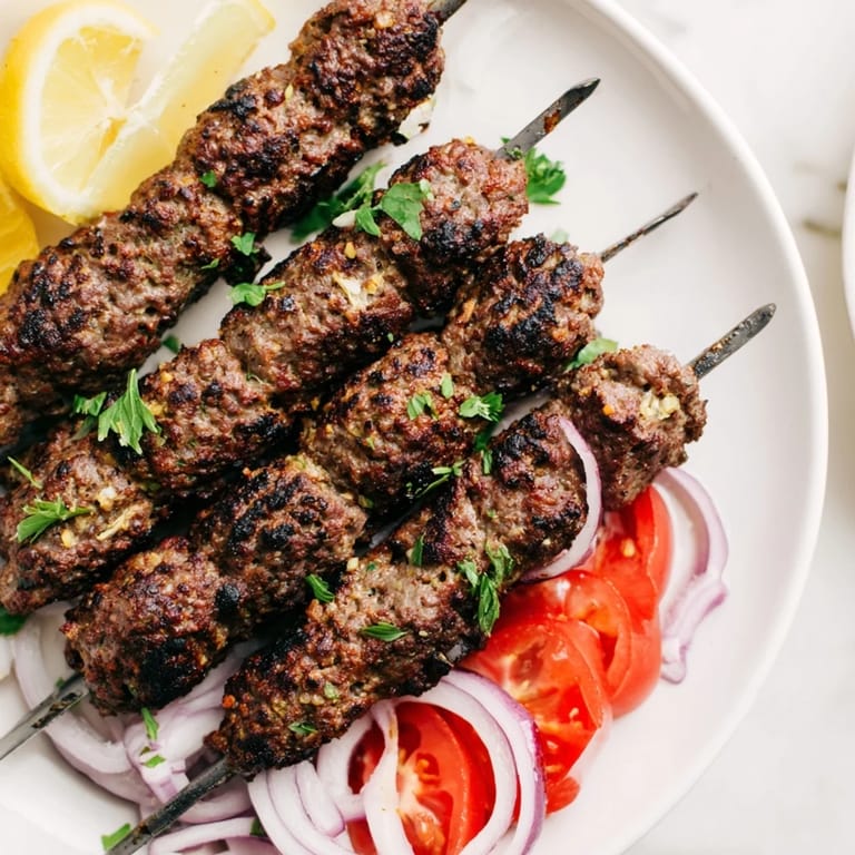 Freshly grilled Iraqi Kebab Tikka: Juicy, spiced meat glistens, ready to be enjoyed with flavorful accompaniments.