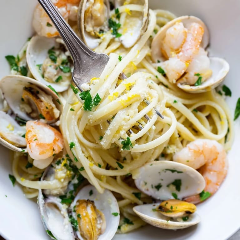 Plated Seafood Linguine served with lemon wedges and parsley, a vibrant Italian-inspired main dish perfect for a coastal dinner.